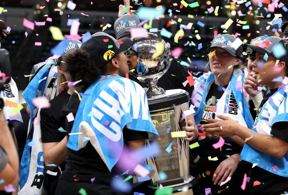 Iowa Hawkeyes guard Tania Davis (11) kisses the trophy as they celebrate their victory over the Maryland Terrapins in the Big Ten Championship Game Sunday, March 10, 2019 at Bankers Life Fieldhouse in Indianapolis, Ind. (Brian Ray/hawkeyesports.com)