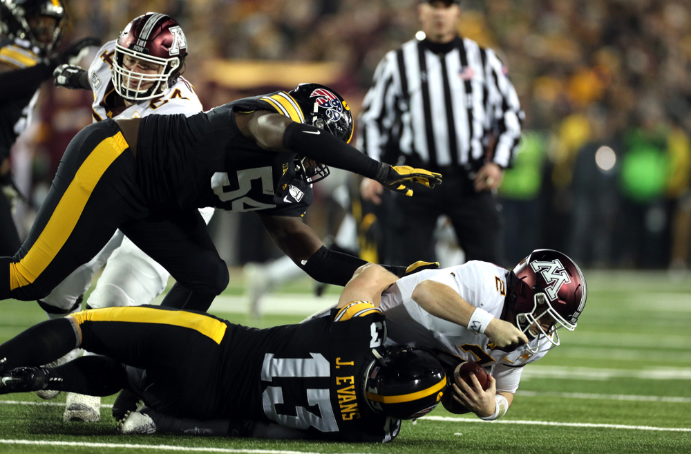 Iowa Hawkeyes defensive tackle Daviyon Nixon (54) and linebacker Joe Evans (13) against the Minnesota Golden Gophers Saturday, November 16, 2019 at Kinnick Stadium. (Brian Ray/hawkeyesports.com)