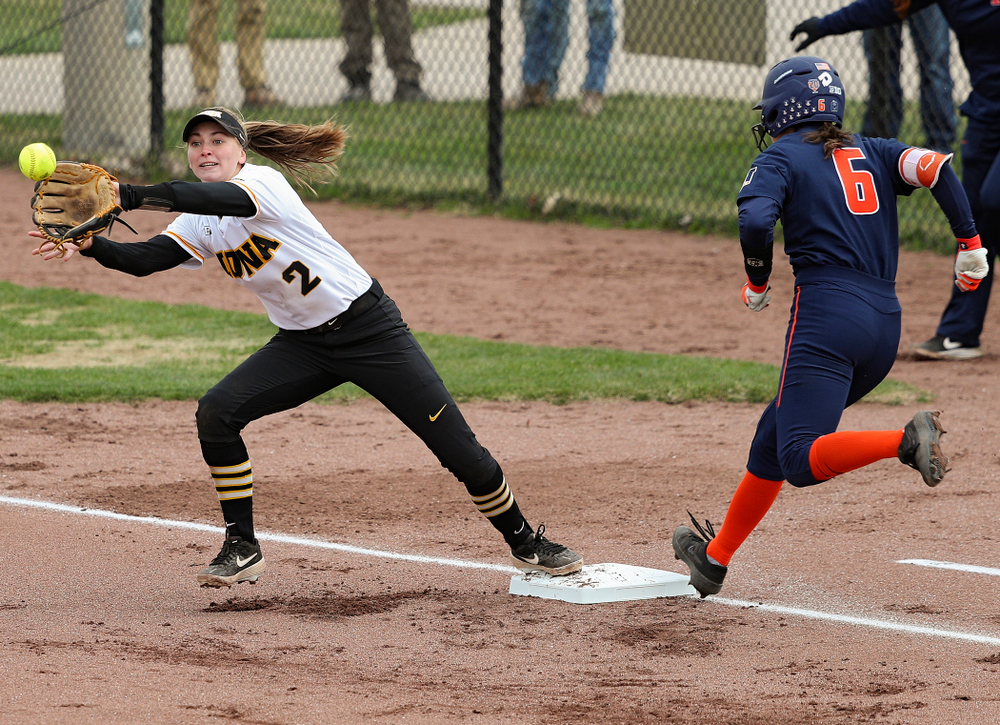 Iowa second baseman Aralee Bogar (2) reaches to pull in a throw as she covers first base on a bunt during the first inning of their game against Illinois at Pearl Field in Iowa City on Friday, Apr. 12, 2019. (Stephen Mally/hawkeyesports.com)