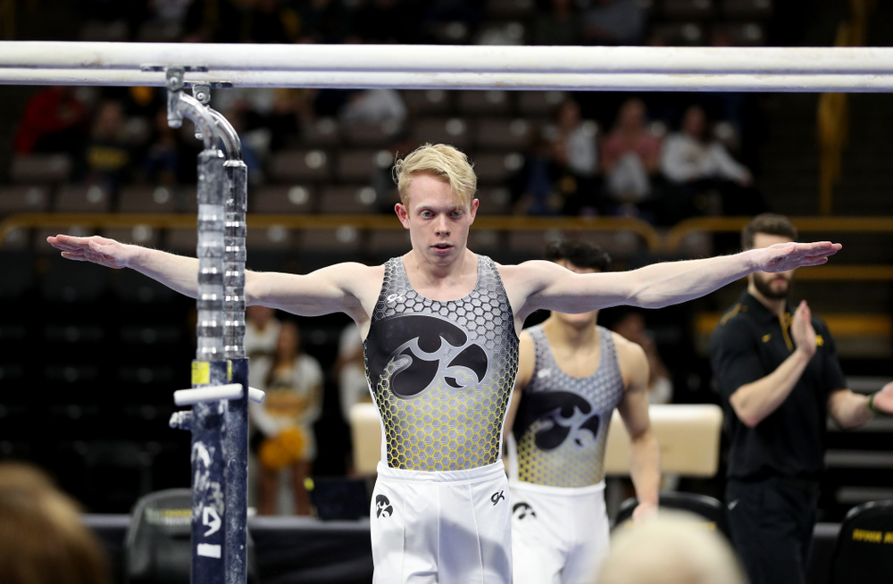 Iowa’s Nick Merryman competes on the parallel bars against UIC and Minnesota Saturday, February 1, 2020 at Carver-Hawkeye Arena. (Brian Ray/hawkeyesports.com)