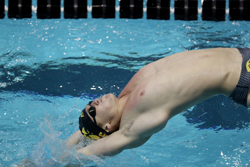 IowaÕs Ryan Purdy competes in the 100 yard backstroke against Notre Dame and Illinois Saturday, January 11, 2020 at the Campus Recreation and Wellness Center. (Brian Ray/hawkeyesports.com)
