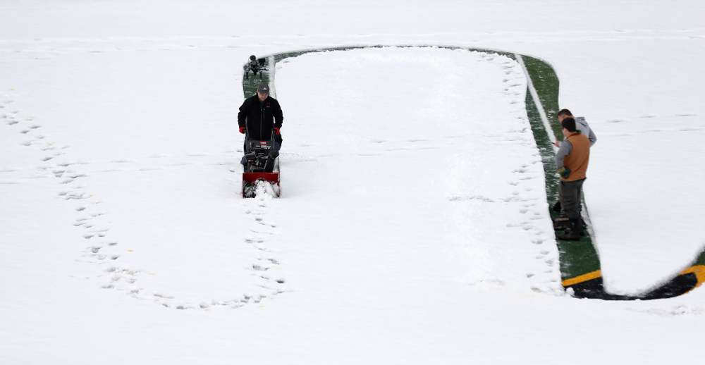 Members of the Iowa Athletics Turf Management staff create the #SnowWave for kids in the Stead Family Children's Hospital Thursday, February
