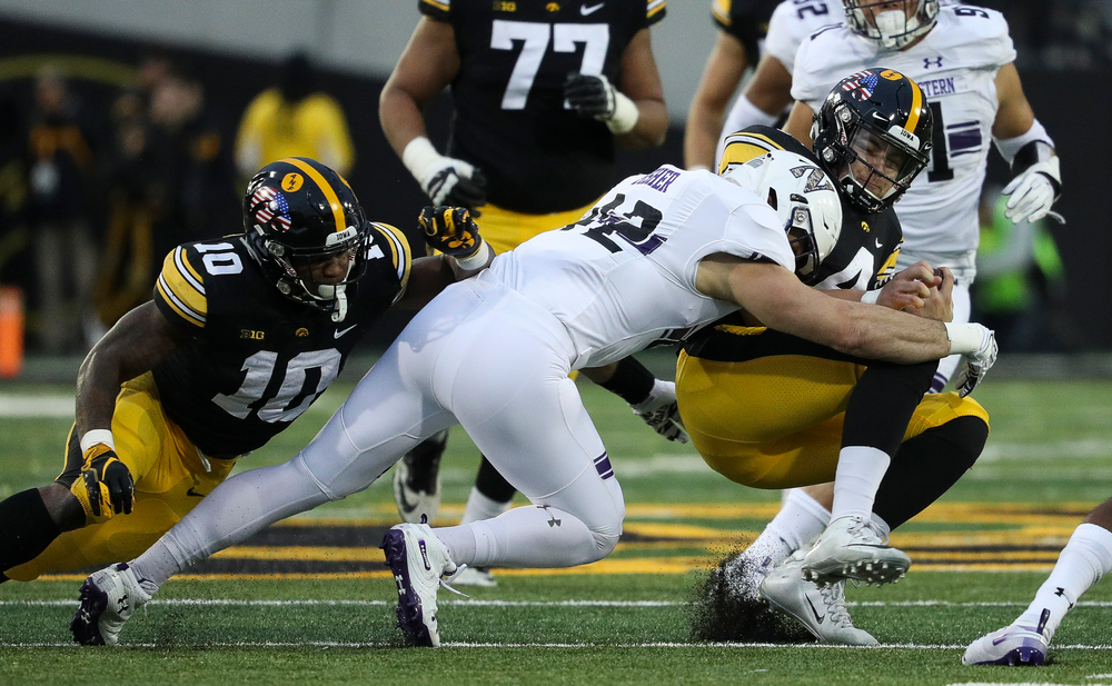 Iowa Hawkeyes quarterback Nate Stanley (4) slides during a game against Northwestern at Kinnick Stadium on November 10, 2018. (Tork Mason/hawkeyesports.com)
