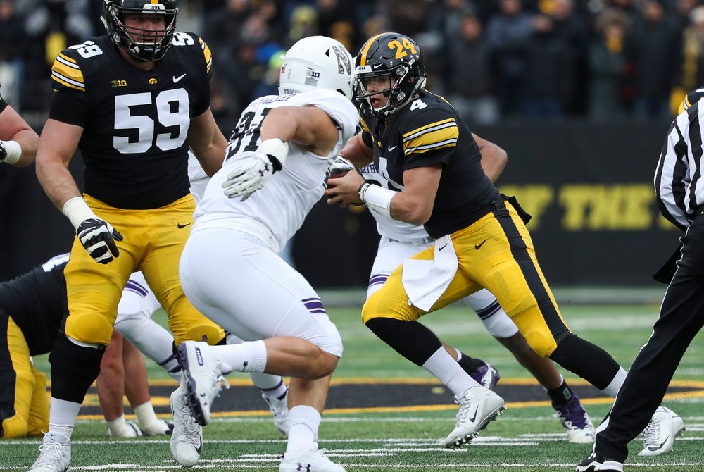 Iowa Hawkeyes quarterback Nate Stanley (4) scrambles during a game against Northwestern at Kinnick Stadium on November 10, 2018. (Tork Mason/hawkeyesports.com)