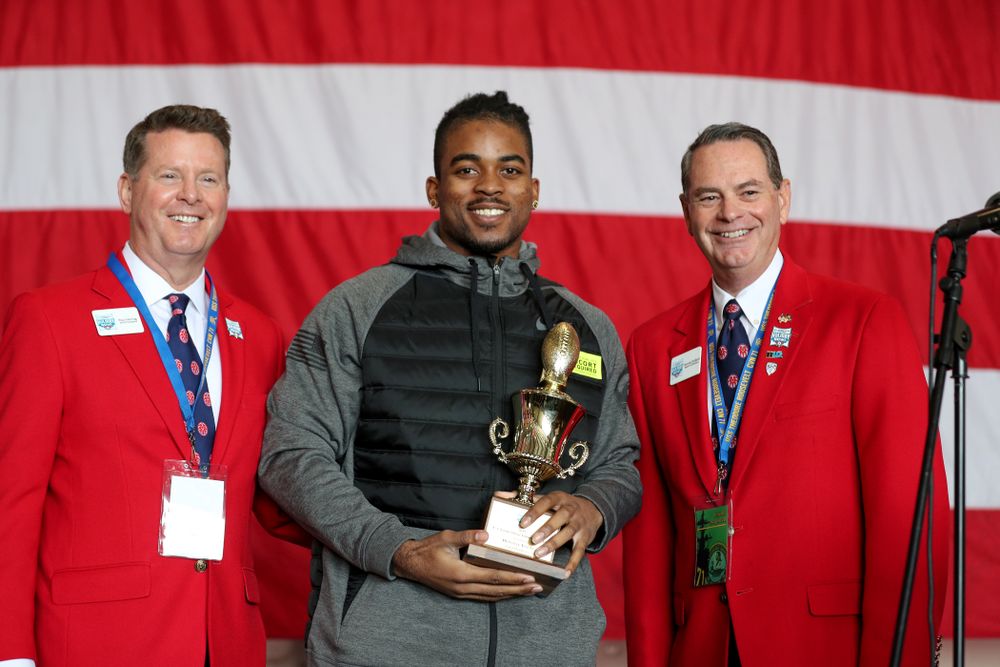 Iowa Hawkeyes defensive back Devonte Young (17) revives the U.S. Grant Sharp AdmiralÕs Trophy during tour of the USS Theodore Roosevelt (CVN-71) Tuesday, December 24, 2019 at the Naval Base Coronado. (Brian Ray/hawkeyesports.com)