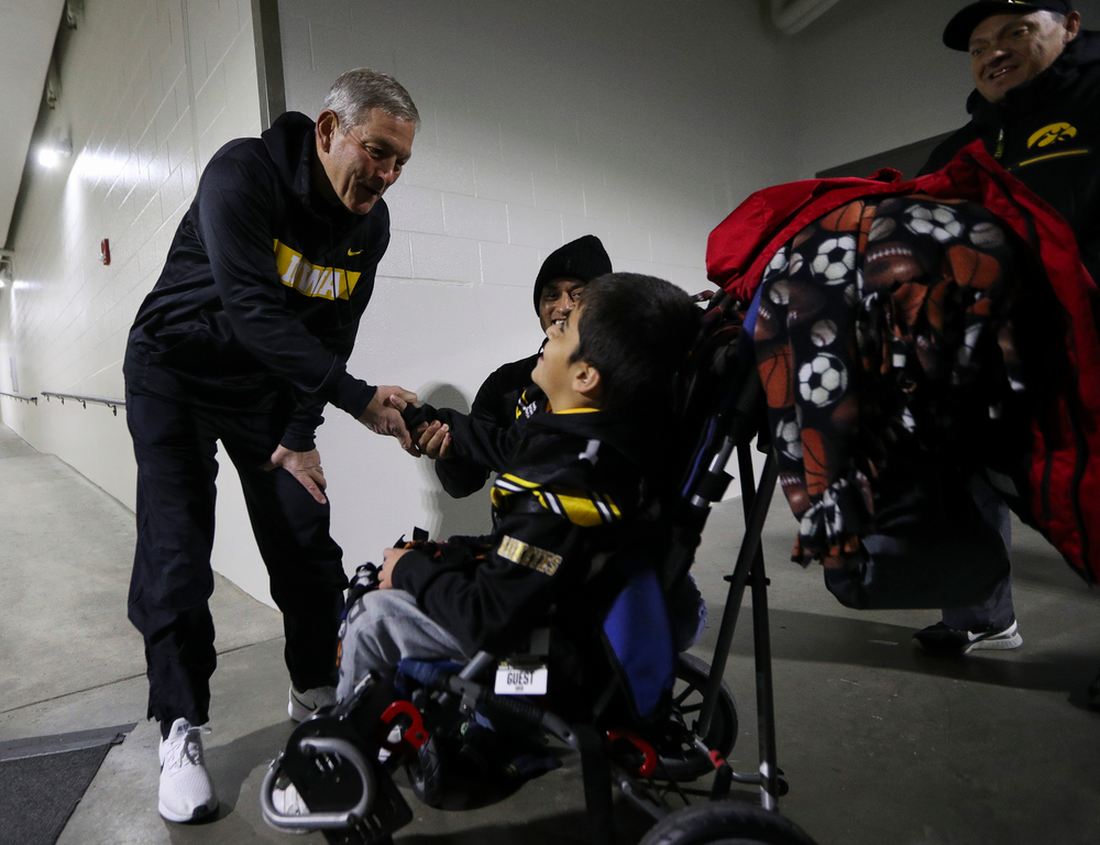 Iowa Hawkeyes head coach Kirk Ferentz shakes hands with Kid Captain Mason Gonzalez before a game against Northwestern at Kinnick Stadium on November 10, 2018. (Tork Mason/hawkeyesports.com)