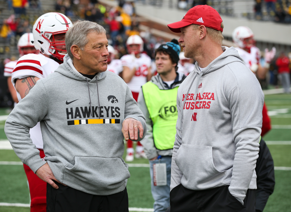 Iowa Hawkeyes head coach Kirk Ferentz talks with Nebraska Cornhuskers head coach Scott Frost before a game against Nebraska at Kinnick Stadium on November 23, 2018. (Tork Mason/hawkeyesports.com)