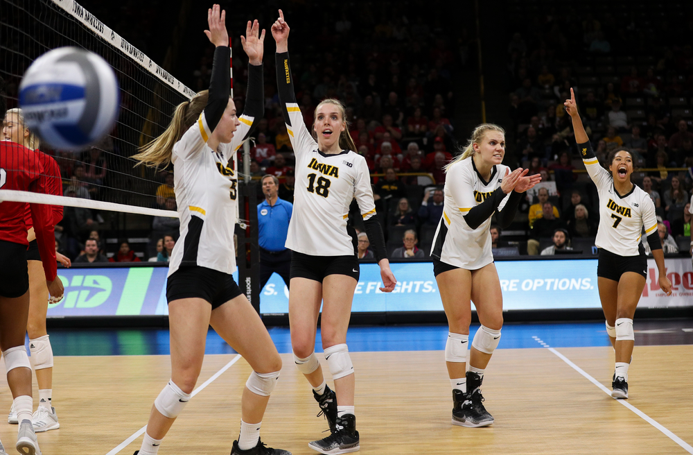Iowa Hawkeyes outside hitter Meghan Buzzerio (5), Iowa Hawkeyes middle blocker Hannah Clayton (18), Iowa Hawkeyes right side hitter Reghan Coyle (8) and Iowa Hawkeyes setter Brie Orr (7) celebrate after winning a point during a match against Nebraska at Carver-Hawkeye Arena on November 7, 2018. (Tork Mason/hawkeyesports.com)