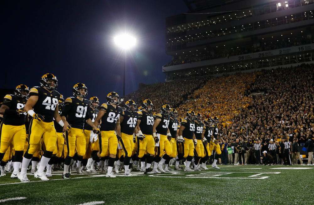 The Iowa Hawkeyes football team swarms the field before a game against Wisconsin at Kinnick Stadium on September 22, 2018. (Tork Mason/hawkeyesports.com)