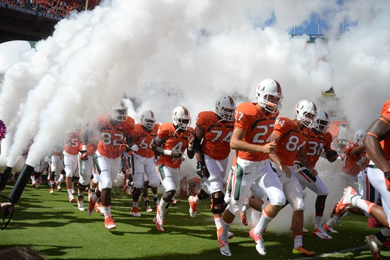 Sebastian the Ibis leads the University of Miami Hurricanes through a tunnel of smoke in a game against the Georgia Tech Yellow Jackets at Sun Life...