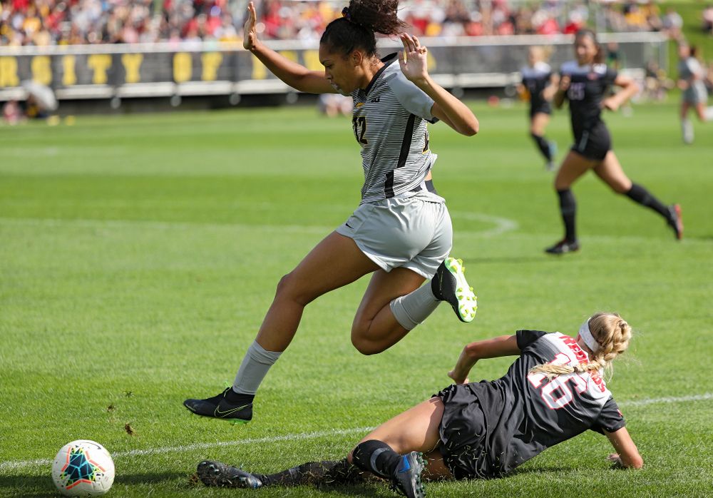Iowa forward Olivia Fiegel (12) hurdles a defender during the first half of their match at the Iowa Soccer Complex in Iowa City on Sunday, Sep 1, 2019. (Stephen Mally/hawkeyesports.com)