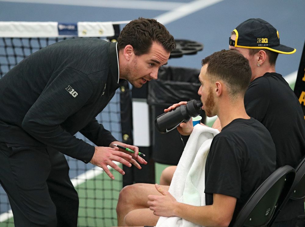 Mellecker Family Head Men's Tennis Coach Ross Wilson )(from left) talks with Kareem Allaf and Nikita Snezhko during their doubles match at the Hawkeye Tennis and Recreation Complex in Iowa City on Friday, March 6, 2020. (Stephen Mally/hawkeyesports.com)