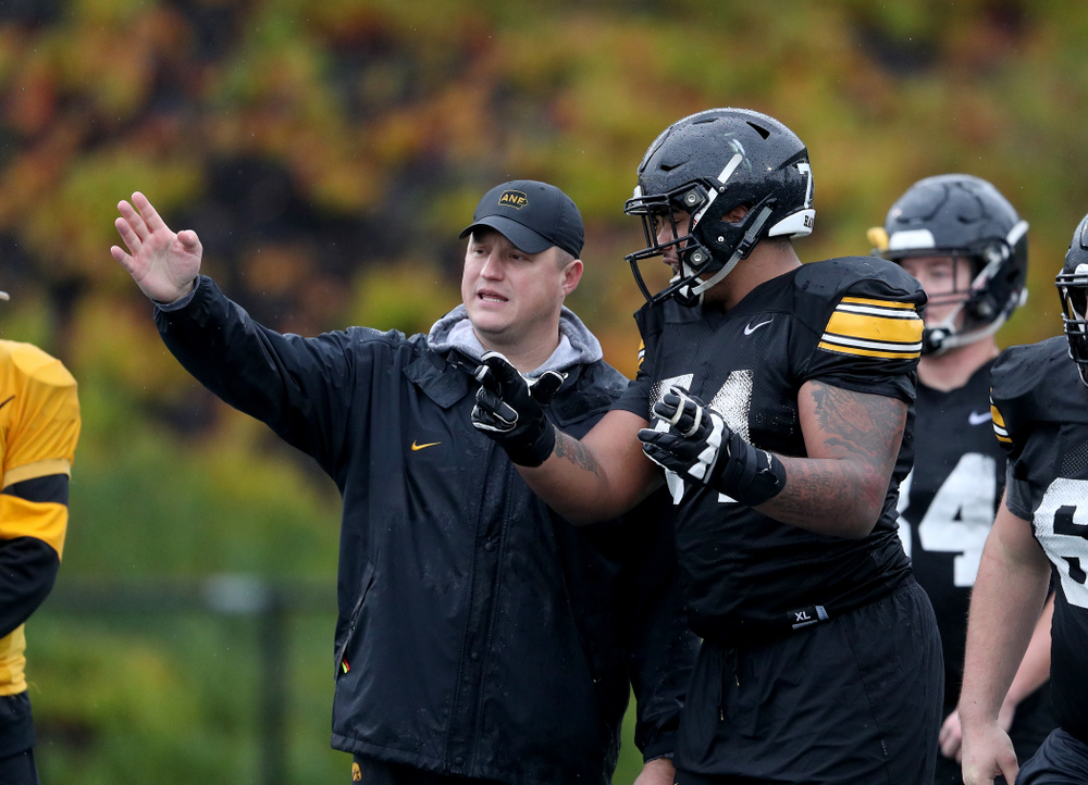 Iowa Hawkeyes offensive coordinator Brian Ferentz talks with offensive lineman Tristan Wirfs (74) during practice Monday, December 23, 2019 at Mesa College in San Diego. (Brian Ray/hawkeyesports.com)