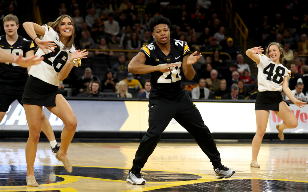Members of the Hawkeye Football team performs with the Iowa Dance Team at halftime of the Iowa Hawkeyes game against the Ohio State Buckeyes Thursday, February 20, 2020 at Carver-Hawkeye Arena. (Brian Ray/hawkeyesports.com)