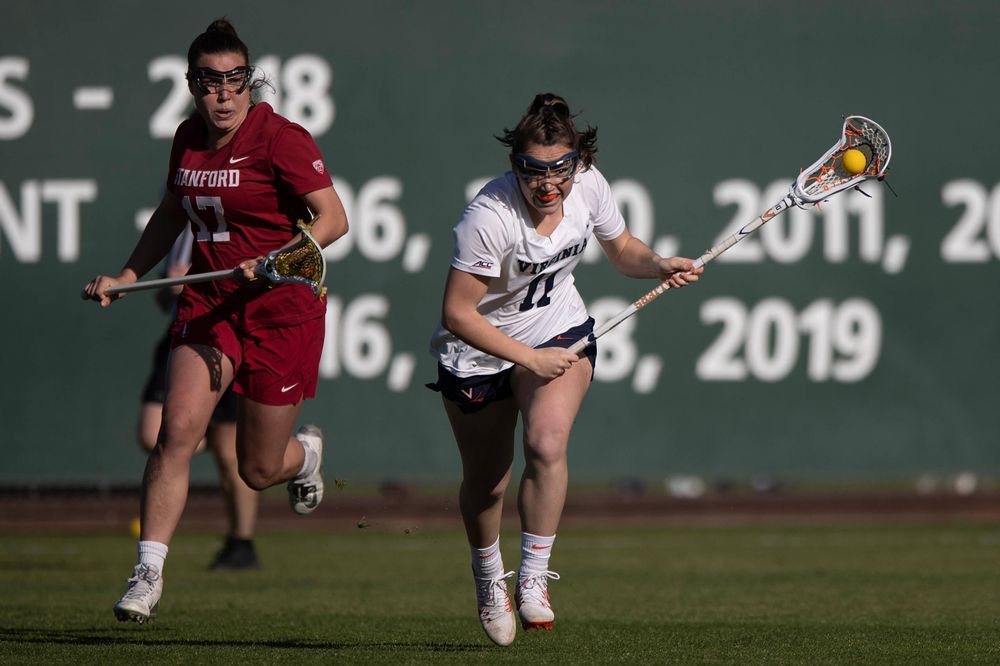STANFORD, California - FEBRUARY 14: Virginia Cavaliers midfield Halle Graham (11) runs up field past Stanford Cardinal attack Katherine Gjertsen (17) during the first half at Cagan Stadium on February 14, 2020 in Stanford, California. The Virginia Cavaliers defeated the Stanford Cardinal 12-11. (Photo by Jason O. Watson)