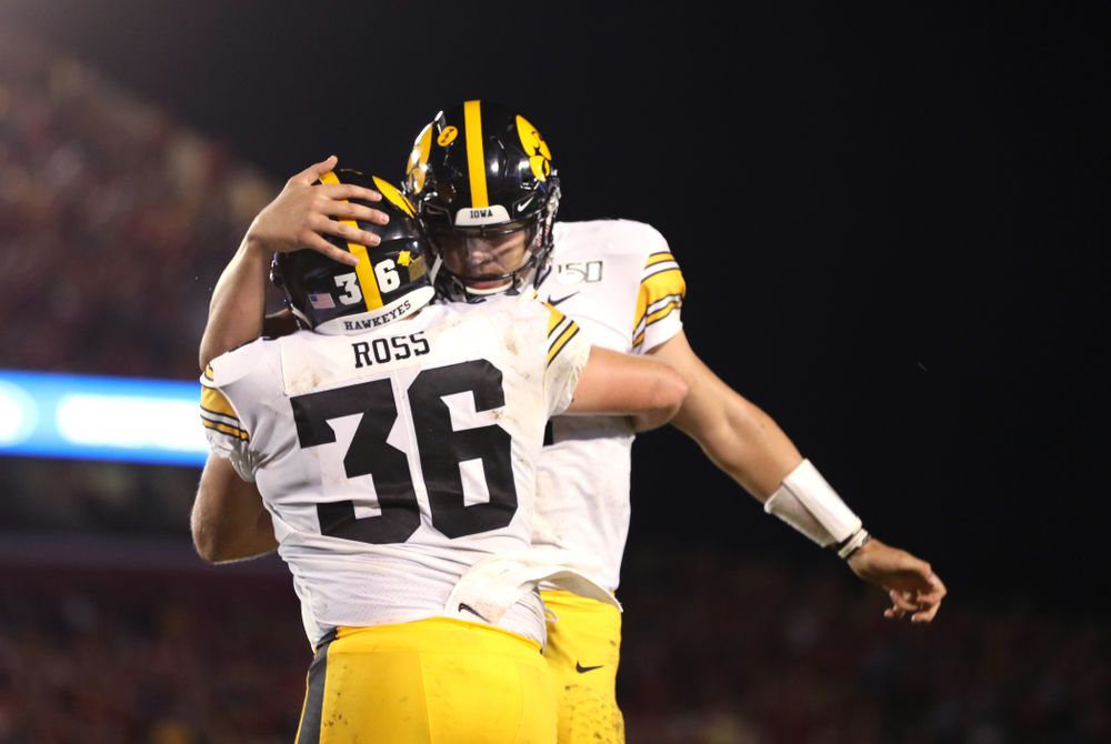 Iowa Hawkeyes quarterback Nate Stanley (4) celebrates with fullback Brady Ross (36) after scoring against the Iowa State Cyclones Saturday, September 14, 2019 in Ames, Iowa. (Brian Ray/hawkeyesports.com)