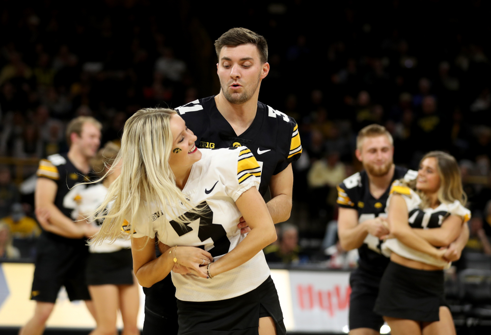 Members of the Hawkeye Football team performs with the Iowa Dance Team at halftime of the Iowa Hawkeyes game against the Ohio State Buckeyes Thursday, February 20, 2020 at Carver-Hawkeye Arena. (Brian Ray/hawkeyesports.com)