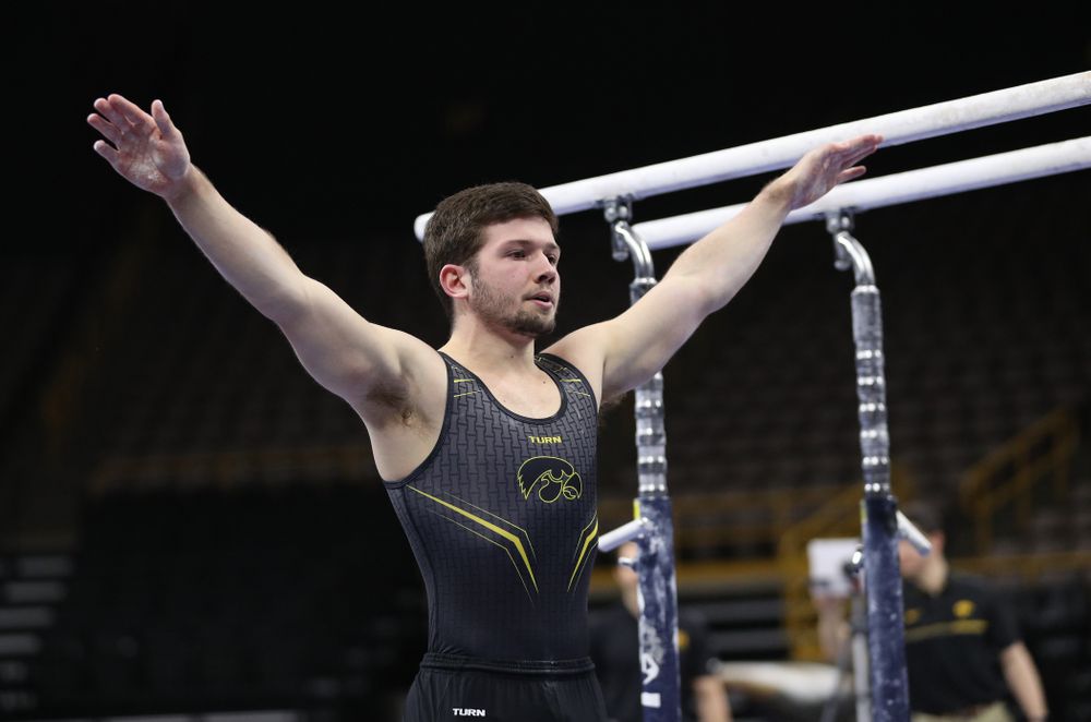 Iowa's Rogelio Vazquez competes on the parallel bars against the Ohio State Buckeyes Saturday, March 16, 2019 at Carver-Hawkeye Arena. (Brian Ray/hawkeyesports.com)