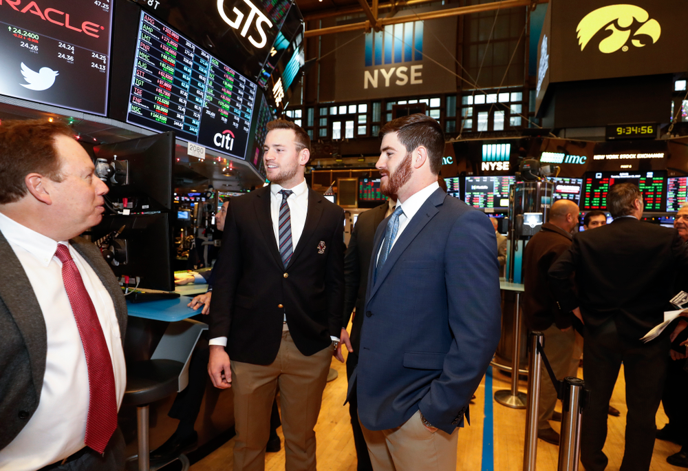 Iowa Hawkeyes linebacker Josey Jewell (43), defensive back Joshua Jackson (15), offensive lineman Sean Welsh (79) and head coach Kirk Ferentz ring the opening bell at the New York Stock Exchange Tuesday, December 26, 2017 in New York. (Brian Ray/hawkeyesports.com)