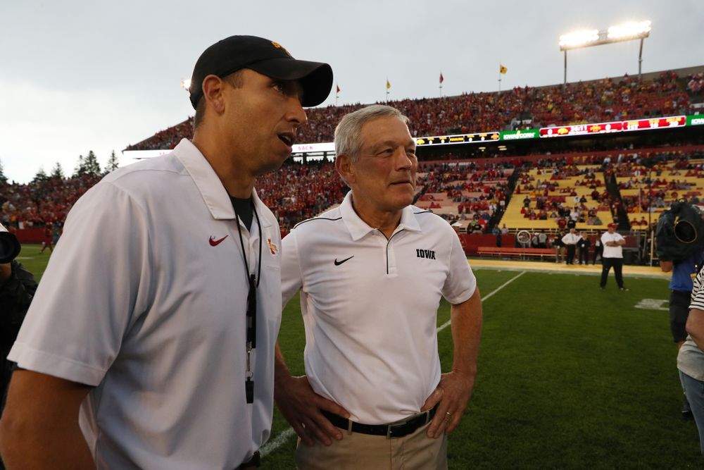 Iowa Hawkeyes head coach Kirk Ferentz talks with Iowa State Cyclones head coach Matt Campbell before their game Saturday, September 14, 2019 at Jack Trice Stadium in Ames, Iowa. (Brian Ray/hawkeyesports.com)
