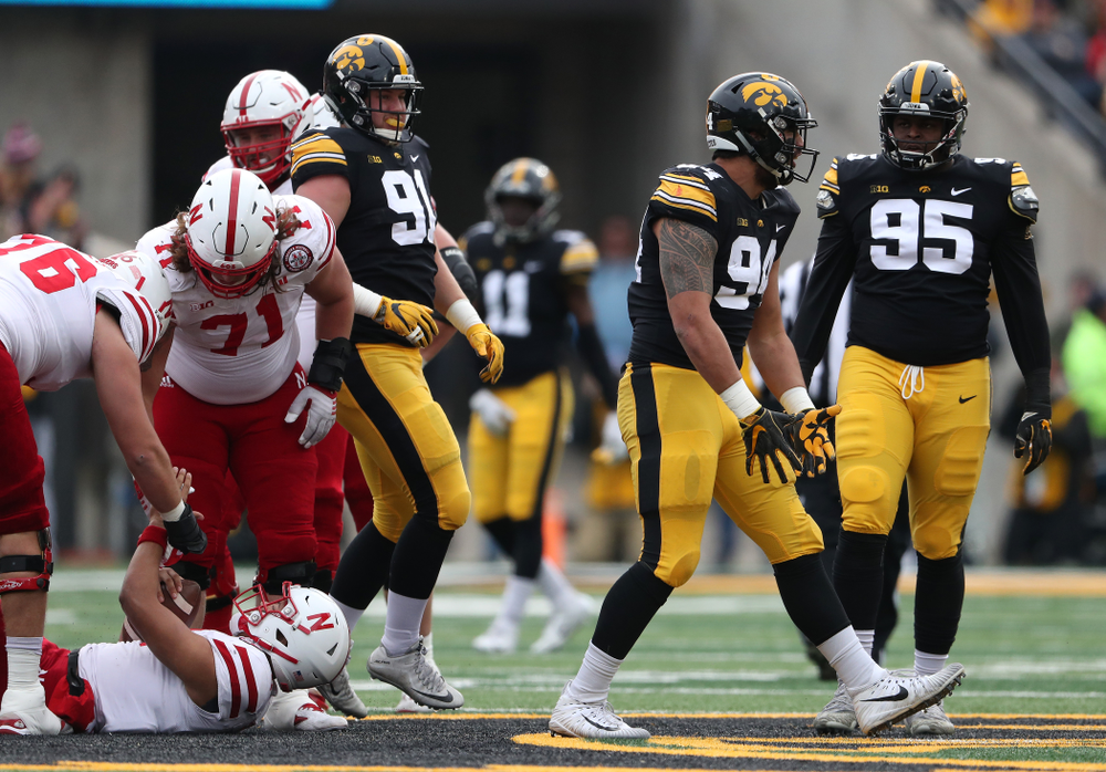Iowa Hawkeyes defensive end A.J. Epenesa (94) sacks Nebraska Cornhuskers quarterback Adrian Martinez (2) Friday, November 23, 2018 at Kinnick Stadium. (Brian Ray/hawkeyesports.com)