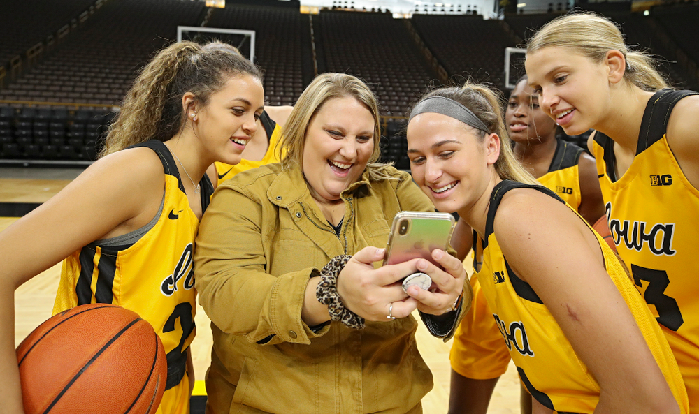 Iowa guard Gabbie Marshall (24), assistant director of marketing Brandee Britt, guard Megan Meyer (11), and forward Logan Cook (23) during Iowa Women’s Basketball Media Day at Carver-Hawkeye Arena in Iowa City on Thursday, Oct 24, 2019. (Stephen Mally/hawkeyesports.com)