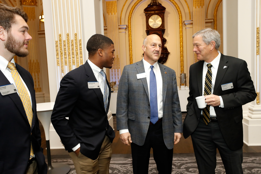 Iowa Hawkeyes linebacker Josey Jewell (43), defensive back Joshua Jackson (15), offensive lineman Sean Welsh (79) and head coach Kirk Ferentz ring the opening bell at the New York Stock Exchange Tuesday, December 26, 2017 in New York. (Brian Ray/hawkeyesports.com)