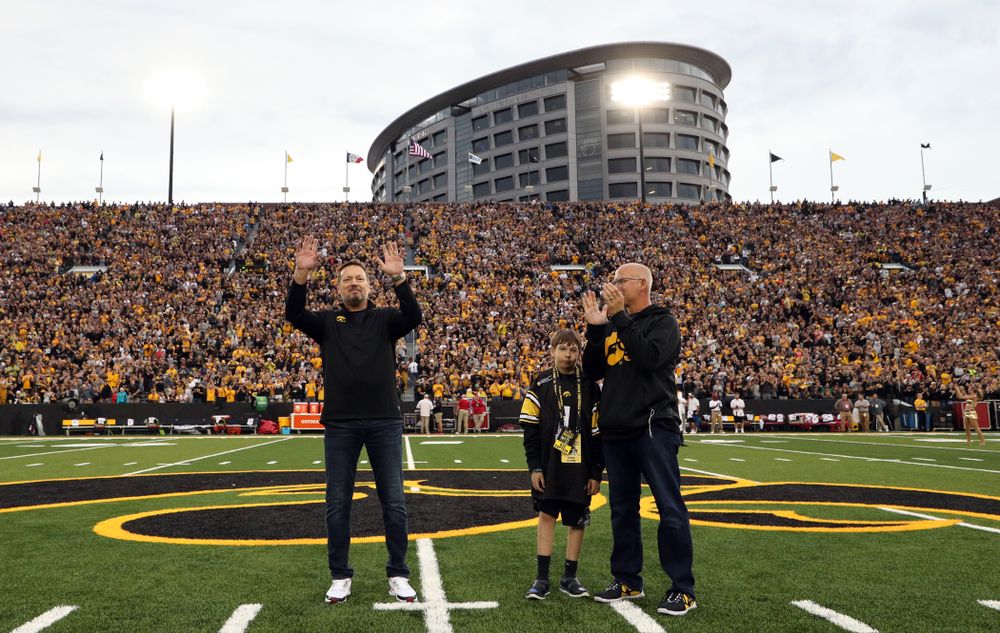 Honorary captain Bob Stoops with Kid Captain Aiden Kasper before the Iowa Hawkeyes game against the Miami RedHawks Saturday, August 31, 2019 at Kinnick Stadium in Iowa City. (Brian Ray/hawkeyesports.com)