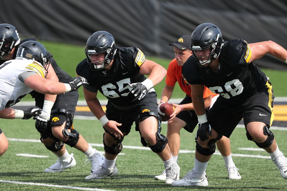 Iowa Hawkeyes offensive lineman Tyler Linderbaum (65) and offensive lineman Landan Paulsen (68) during Fall Camp Practice No. 4 Monday, August 5, 2019 at the Ronald D. and Margaret L. Kenyon Football Practice Facility. (Brian Ray/hawkeyesports.com)