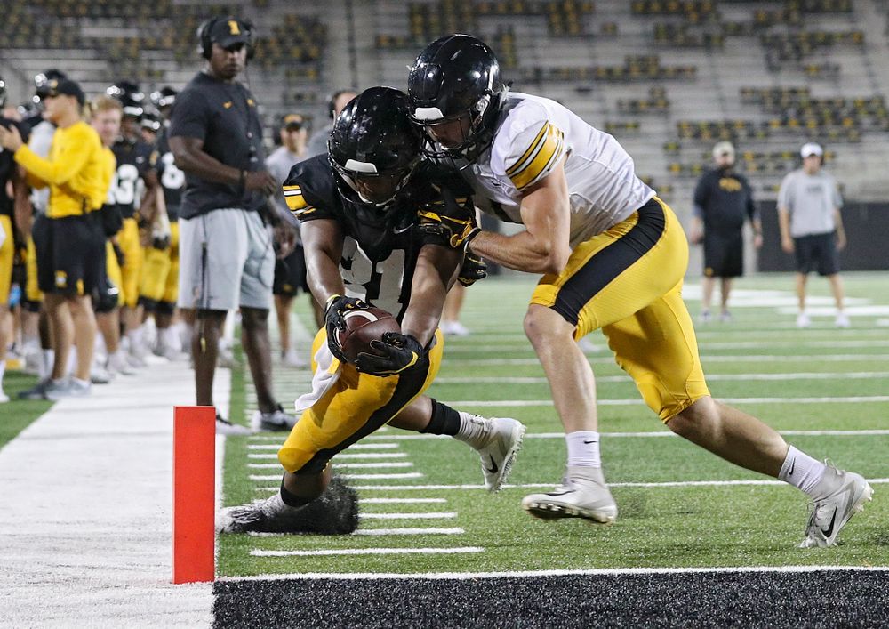 Iowa Hawkeyes running back Ivory Kelly-Martin (21) dives for the pylon as he is hit by defensive back Wes Dvorak (1) during Fall Camp Practice No. 12 at Kinnick Stadium in Iowa City on Thursday, Aug 15, 2019. (Stephen Mally/hawkeyesports.com)