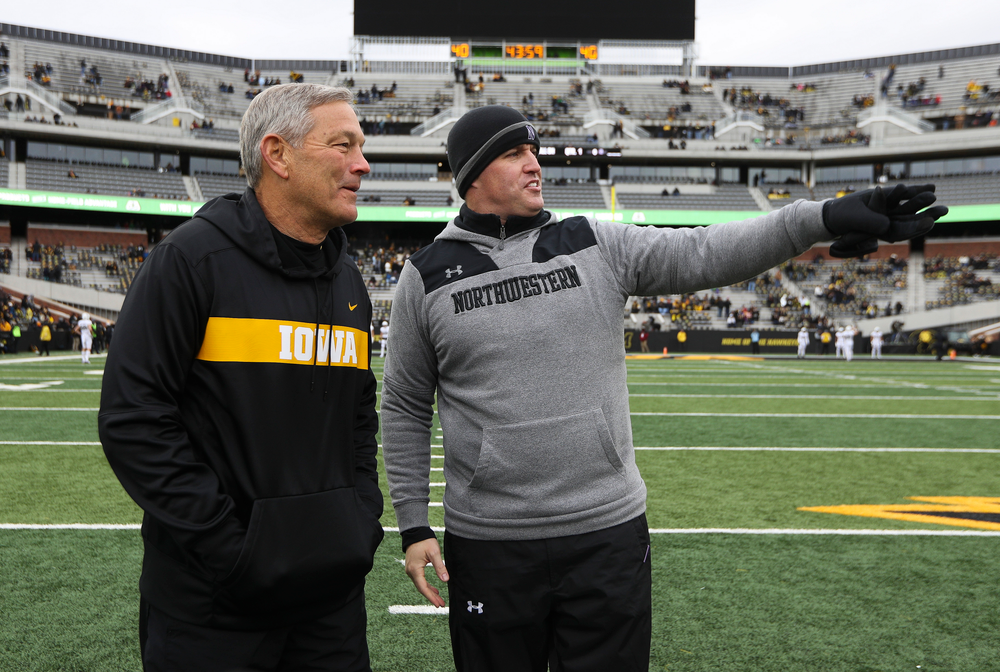 Iowa Hawkeyes head coach Kirk Ferentz talks with Northwestern Wildcats head coach Pat Fitzgerald before a game against Northwestern at Kinnick Stadium on November 10, 2018. (Tork Mason/hawkeyesports.com)