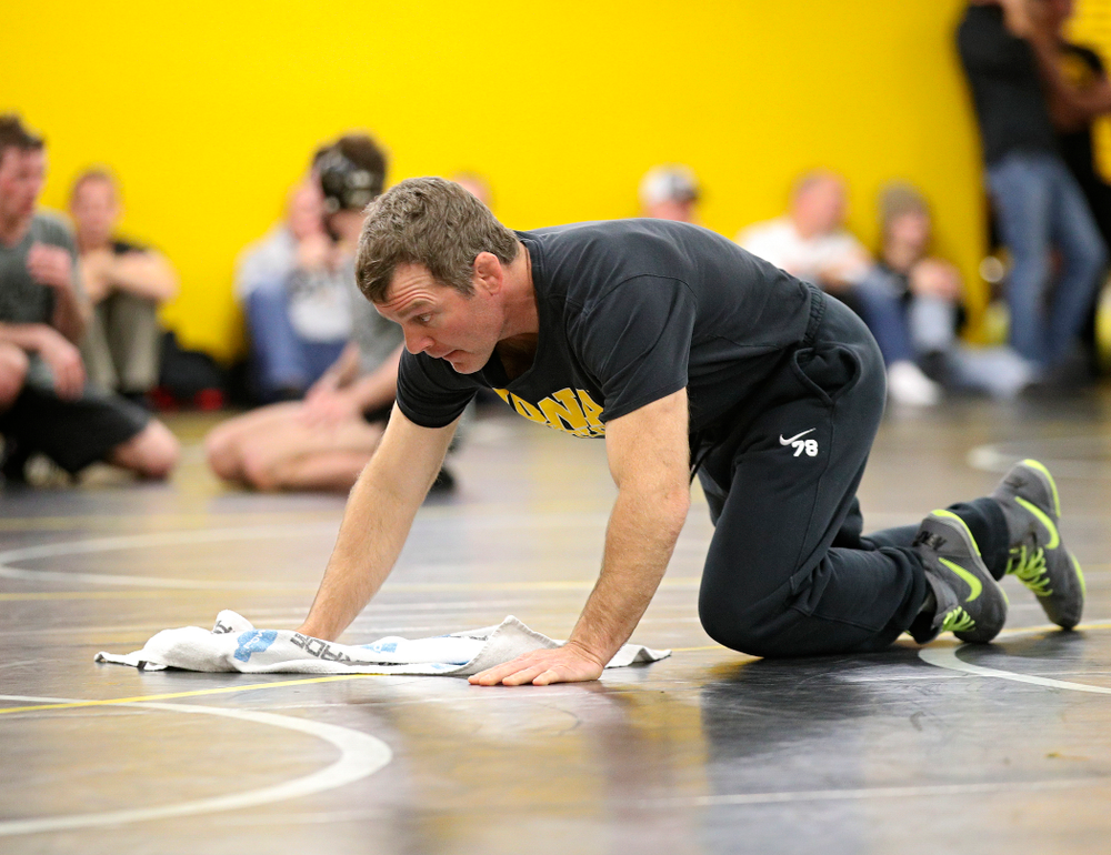 Iowa head coach Tom Brands wipes the mat before their preseason match at the Dan Gable Wrestling Complex at Carver-Hawkeye Arena in Iowa City on Thursday, Nov 7, 2019. (Stephen Mally/hawkeyesports.com)