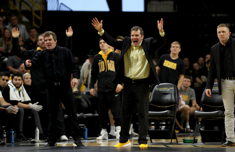 Iowa head coach Tom Brands and associate head coach Terry Brands work the sideline as Michael Kemerer wrestles Ohio State’s Kaleb Romero at 174 pounds Friday, January 24, 2020 at Carver-Hawkeye Arena. Kemerer won the match 7-1. (Brian Ray/hawkeyesports.com)