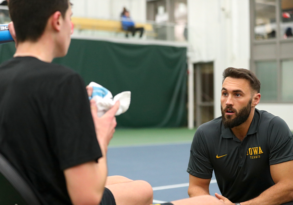 Iowa assistant coach Lloyd Bruce-Burgess (right) talks with Matt Clegg during his doubles match at the Hawkeye Tennis and Recreation Complex in Iowa City on Friday, February 14, 2020. (Stephen Mally/hawkeyesports.com)
