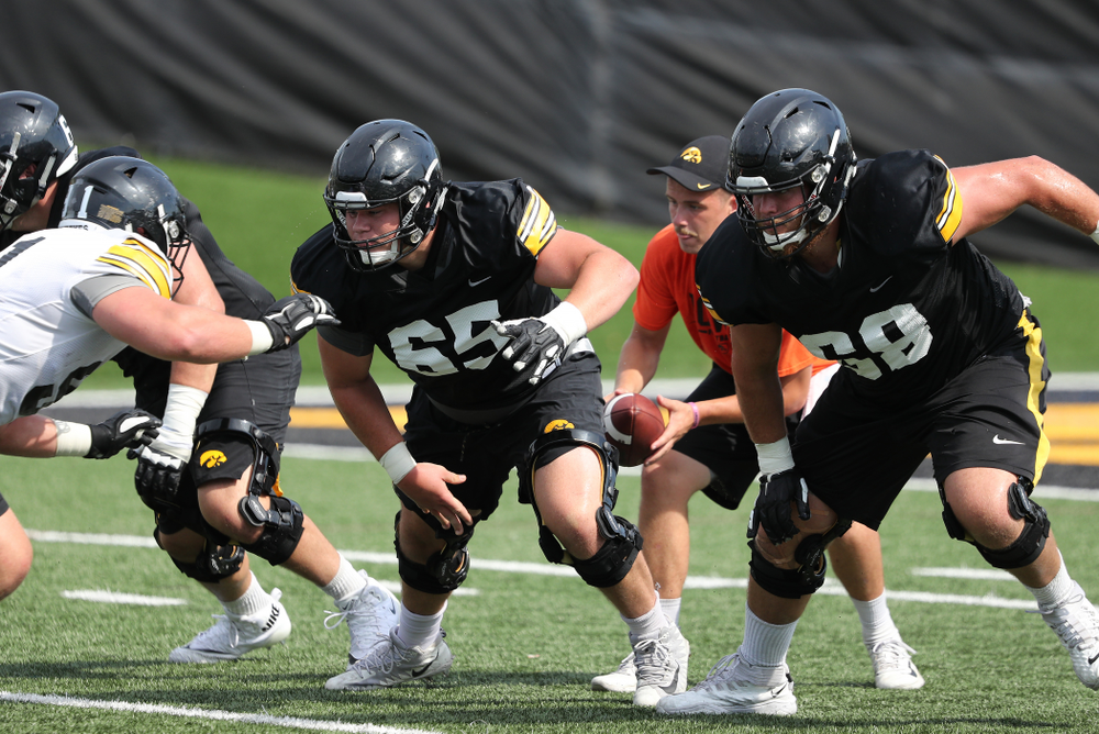 Iowa Hawkeyes offensive lineman Tyler Linderbaum (65) and offensive lineman Landan Paulsen (68) during Fall Camp Practice No. 4 Monday, August 5, 2019 at the Ronald D. and Margaret L. Kenyon Football Practice Facility. (Brian Ray/hawkeyesports.com)