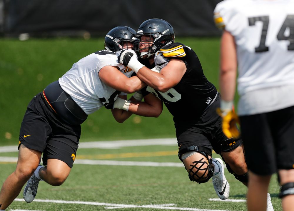 Iowa Hawkeyes offensive lineman Dalton Ferguson (76) and defensive end Sam Brincks (90) during fall camp practice No. 9 Friday, August 10, 2018 at the Kenyon Practice Facility. (Brian Ray/hawkeyesports.com)