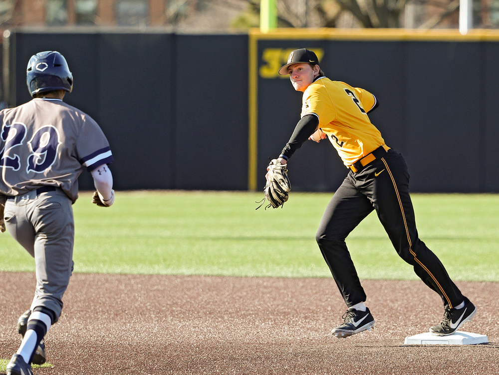 Iowa Hawkeyes shortstop Brendan Sher (2) steps on second base before throwing to first base while turning a double play during the third inning of their game at Duane Banks Field in Iowa City on Tuesday, Apr. 2, 2019. (Stephen Mally/hawkeyesports.com)