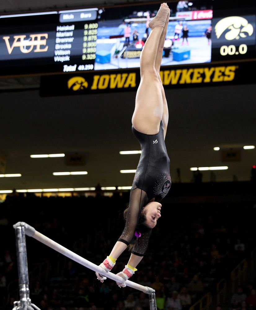 Iowa’s Carina Tolan competes on the bars against Michigan Friday, February 14, 2020 at Carver-Hawkeye Arena. (Brian Ray/hawkeyesports.com)