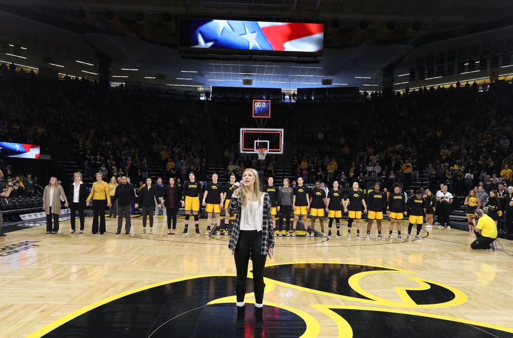 Iowa Hawkeyes head coach Lisa Bluder watches as her daughter Emma sings the National Anthem before the Iowa Hawkeyes game against the Northwestern Wildcats Sunday, March 3, 2019 at Carver-Hawkeye Arena. (Brian Ray/hawkeyesports.com)