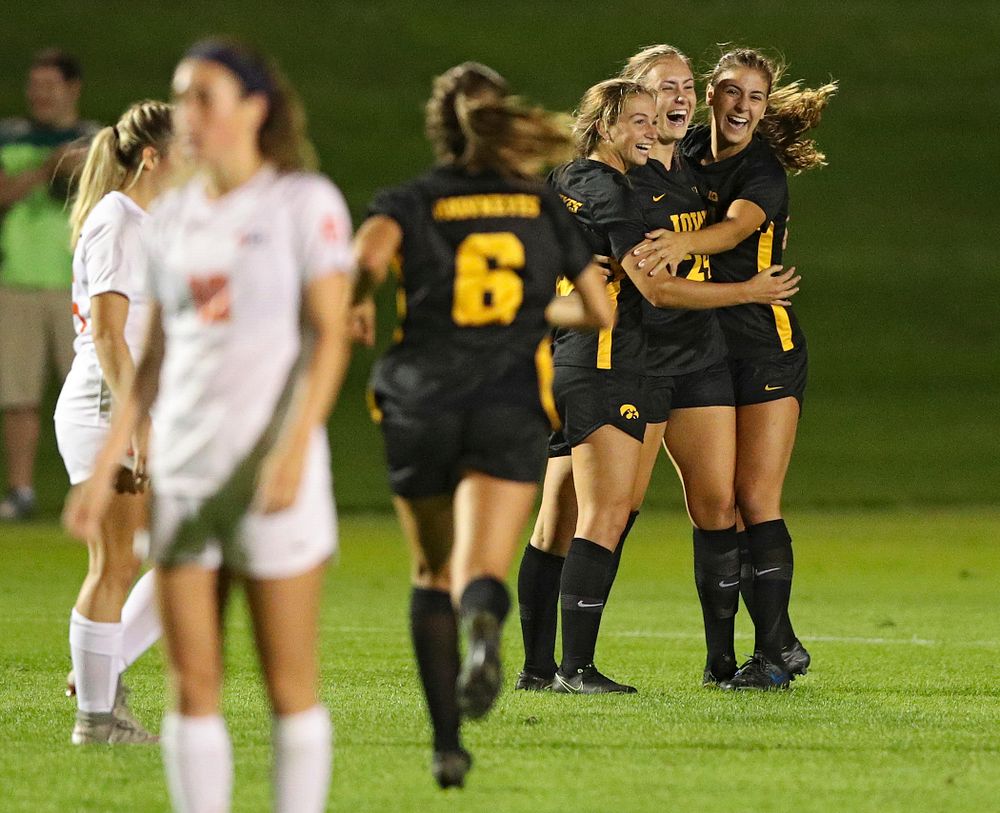 Iowa defender Sara Wheaton (24) celebrates her goal with defender Riley Whitaker (5) and defender Hannah Drkulec (17) as midfielder Isabella Blackman (6) comes running in during the first half of their match against Illinois at the Iowa Soccer Complex in Iowa City on Thursday, Sep 26, 2019. (Stephen Mally/hawkeyesports.com)