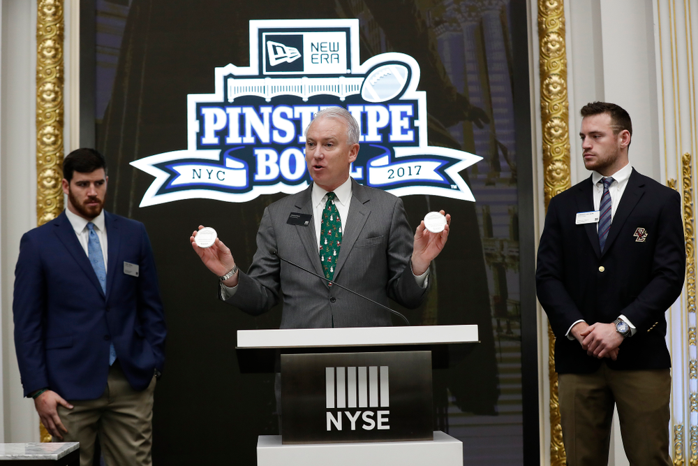 Iowa Hawkeyes linebacker Josey Jewell (43), defensive back Joshua Jackson (15), offensive lineman Sean Welsh (79) and head coach Kirk Ferentz ring the opening bell at the New York Stock Exchange Tuesday, December 26, 2017 in New York. (Brian Ray/hawkeyesports.com)