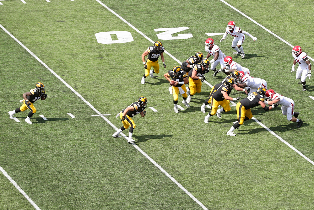 Iowa Hawkeyes quarterback Nate Stanley (4) prepares to hand off to running back Mekhi Sargent (10) during the second quarter of their Big Ten Conference football game at Kinnick Stadium in Iowa City on Saturday, Sep 7, 2019. (Stephen Mally/hawkeyesports.com)