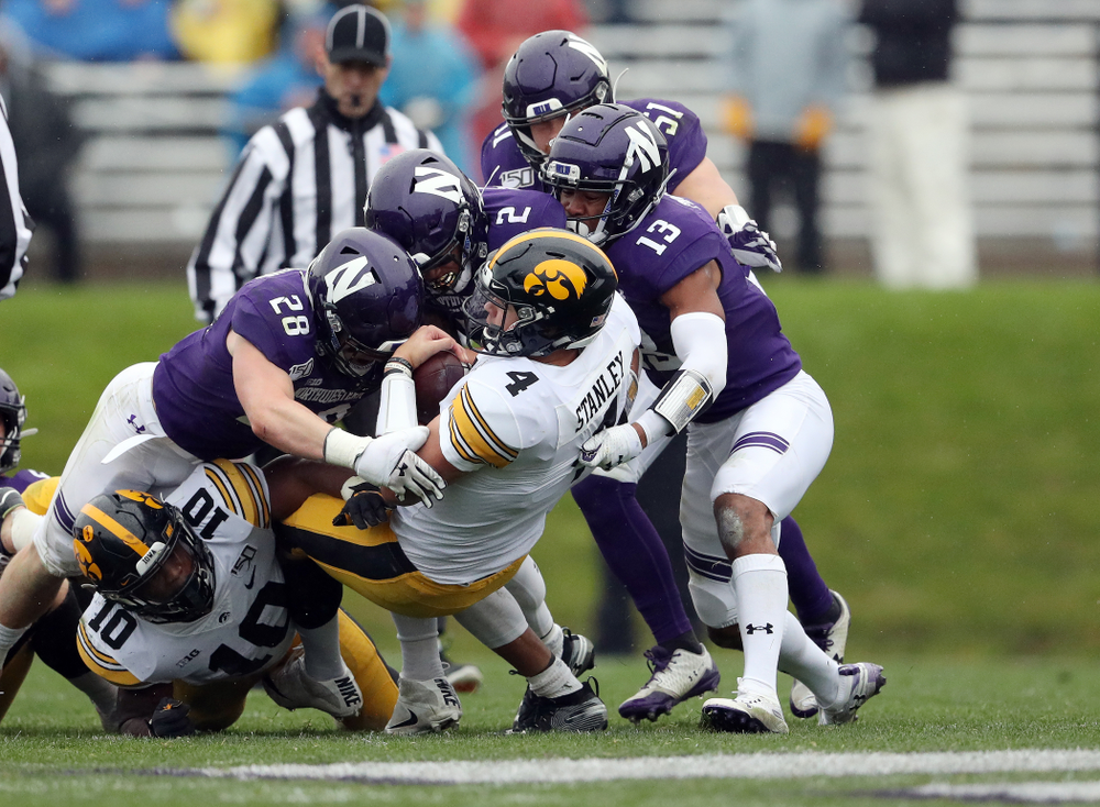 Iowa Hawkeyes quarterback Nate Stanley (4) picks up a first down against the Northwestern Wildcats Saturday, October 26, 2019 at Ryan Field in Evanston, Ill. (Brian Ray/hawkeyesports.com)