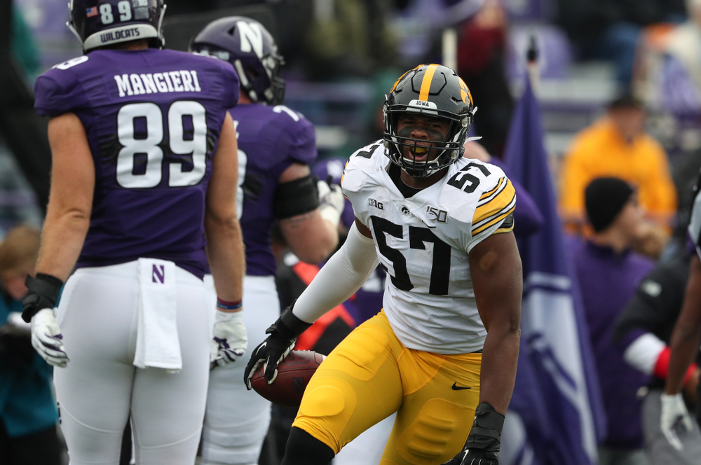Iowa Hawkeyes defensive end Chauncey Golston (57) celebrates an interception against the Northwestern Wildcats Saturday, October 26, 2019 at Ryan Field in Evanston, Ill. (Brian Ray/hawkeyesports.com)