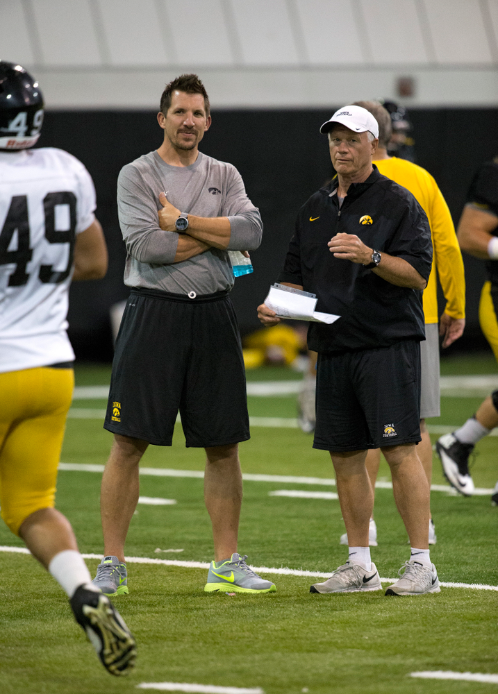 Former Hawkeye All-American tight end and 11 year NFL veteran Dallas Clark talks with defensive line coach Reese Morgan during the 19th practice of fall camp Wednesday, Aug. 19, 2015 in Iowa City. (Brian Ray/hawkeyesports.com)
