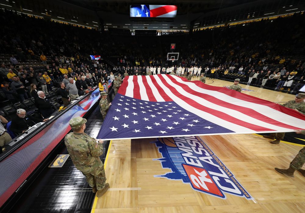 Service members stretch out a large American flag before the Iowa Hawkeyes game against UW Green Bay Sunday, November 11, 2018 at Carver-Hawkeye Arena. (Brian Ray/hawkeyesports.com)