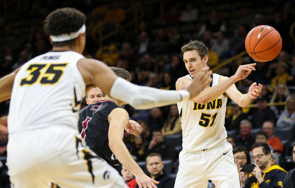 Iowa Hawkeyes forward Nicholas Baer (51) makes an entry pass to Iowa Hawkeyes forward Cordell Pemsl (35) during a game against Guilford College at Carver-Hawkeye Arena on November 4, 2018. (Tork Mason/hawkeyesports.com)