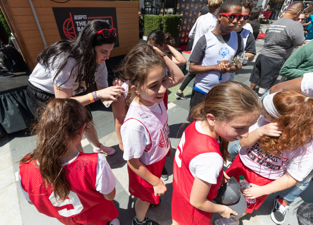 Iowa Hawkeyes forward Megan Gustafson (10) signs autographs following a youth clinic and game Friday, April 12, 2019 in the XBOX Plaza at LA Live. (Brian Ray/hawkeyesports.com)