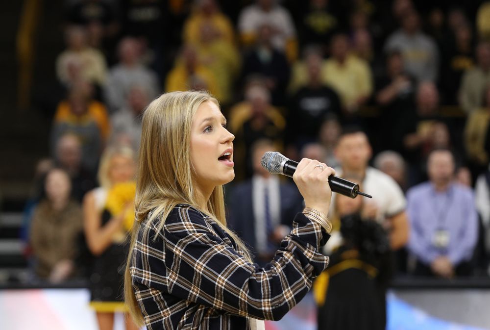 Iowa Hawkeyes head coach Lisa Bluder watches as her daughter Emma sings the National Anthem before the Iowa Hawkeyes game against the Northwestern Wildcats Sunday, March 3, 2019 at Carver-Hawkeye Arena. (Brian Ray/hawkeyesports.com)