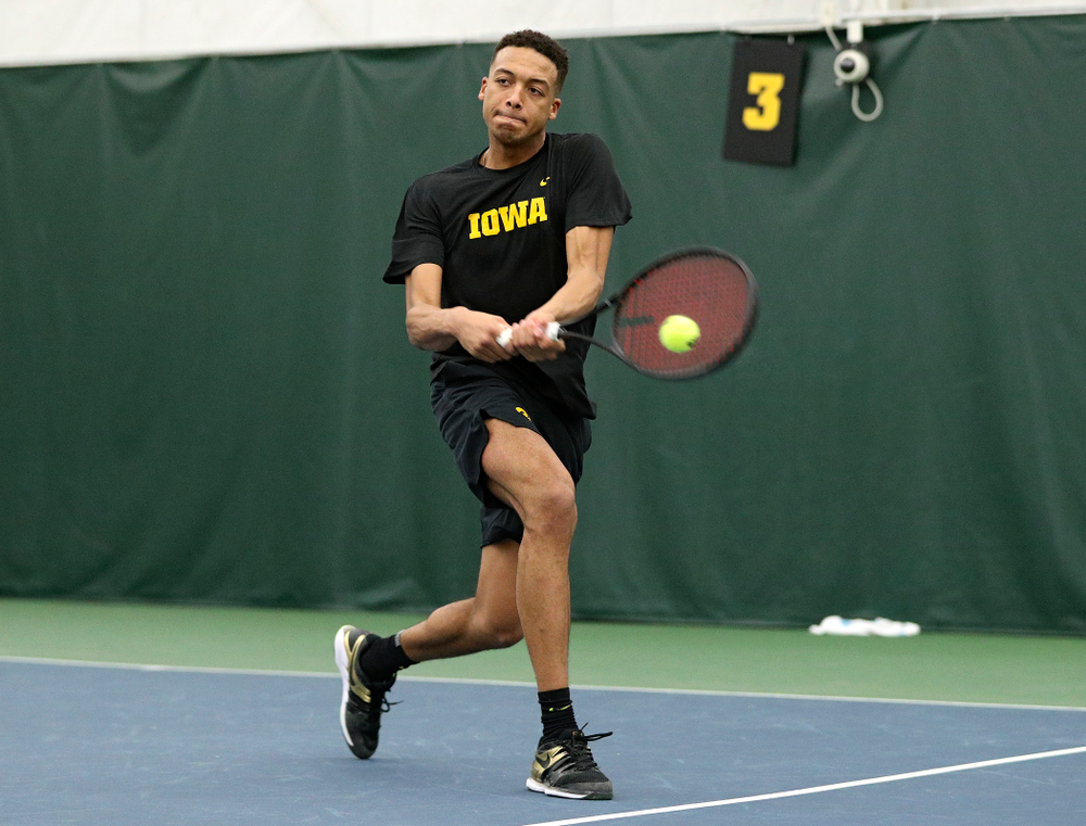 Iowa’s Oliver Okonkwo returns a shot during his singles match at the Hawkeye Tennis and Recreation Complex in Iowa City on Friday, February 14, 2020. (Stephen Mally/hawkeyesports.com)